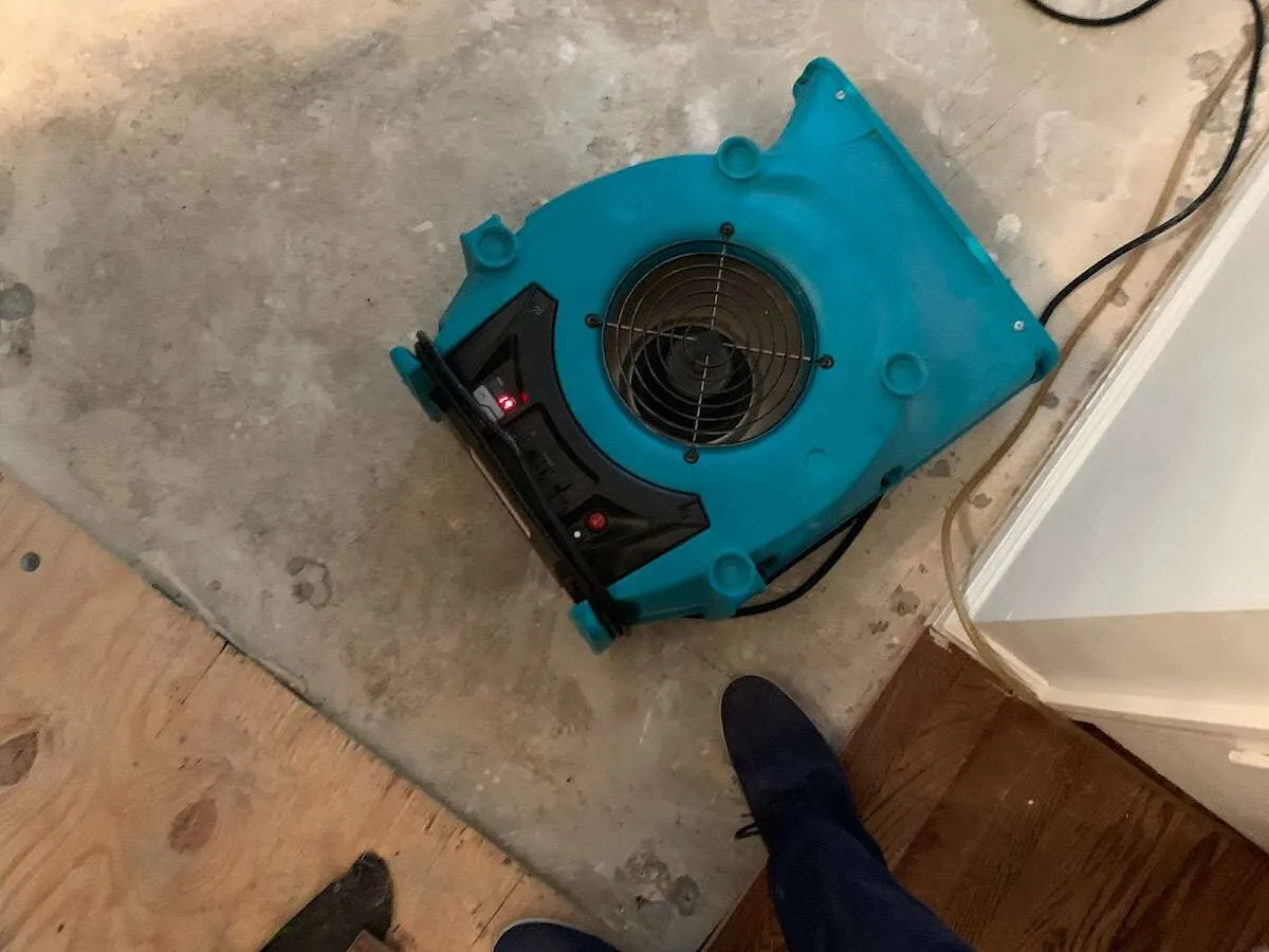 Air mover drying subfloor during Commercial Water Damage Restoration in Kuna